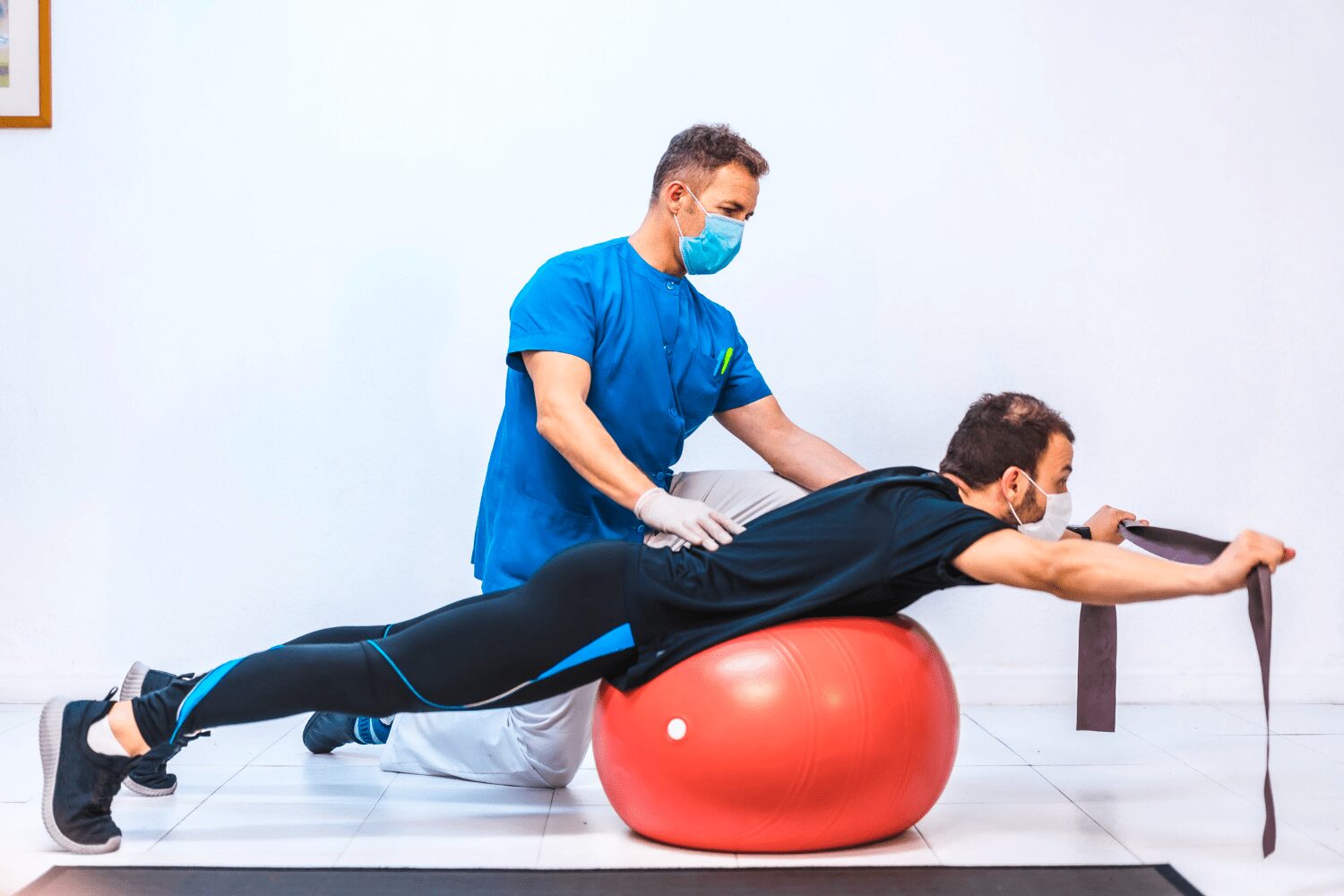 physiotherapist-with-mask-patient-doing-exercises-with-rubber-giant-ball-physiotherapy-with-protective-measures-coronavirus-pandemic-covid-19-osteopathy-sports-chiromassage physiotherapist